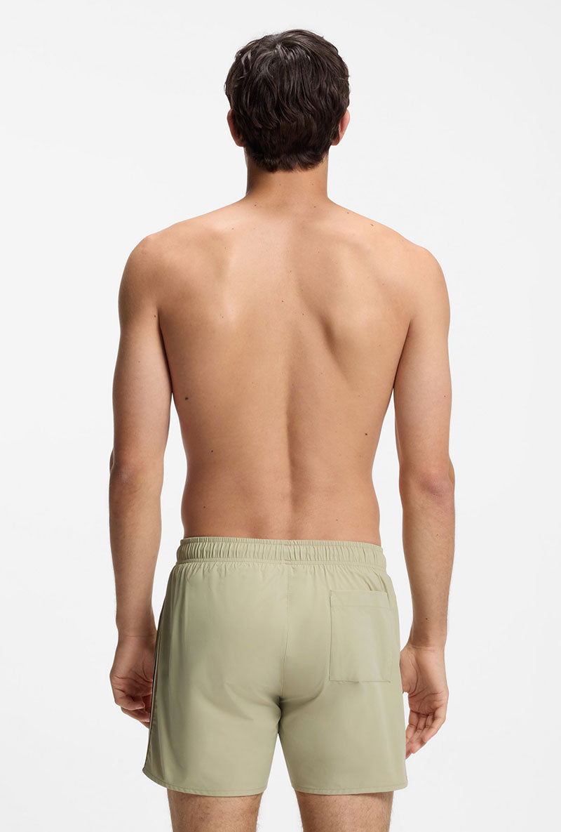 Back image of a model wearing Boss iconic swimshorts in beige, by brand Boss