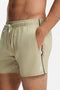 Front image of a model wearing the Boss iconic swimshorts in beige, by brand Boss