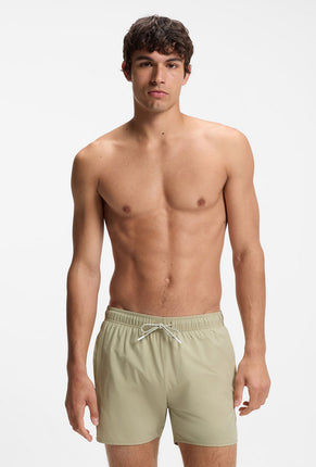Front image of a model wearing Boss iconic swimshorts in beige, by brand Boss