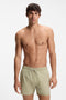 Front image of a model wearing Boss iconic swimshorts in beige, by brand Boss