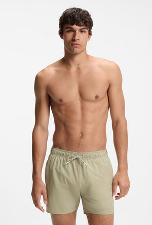 Front image of a model wearing the Boss iconic swimshorts in beige, by brand Boss
