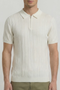 Front detail image of a model wearing the Deep colin zip polo in white, by brand Deep