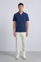 Front image of a model wearing Deep leroy polo in navy, by brand Deep