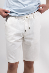 Front image of a model wearing the Deep new wave cotton shorts in off white, by brand Deep