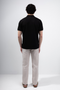 Back image of a model wearing the Deep premium polo in black, by brand Deep