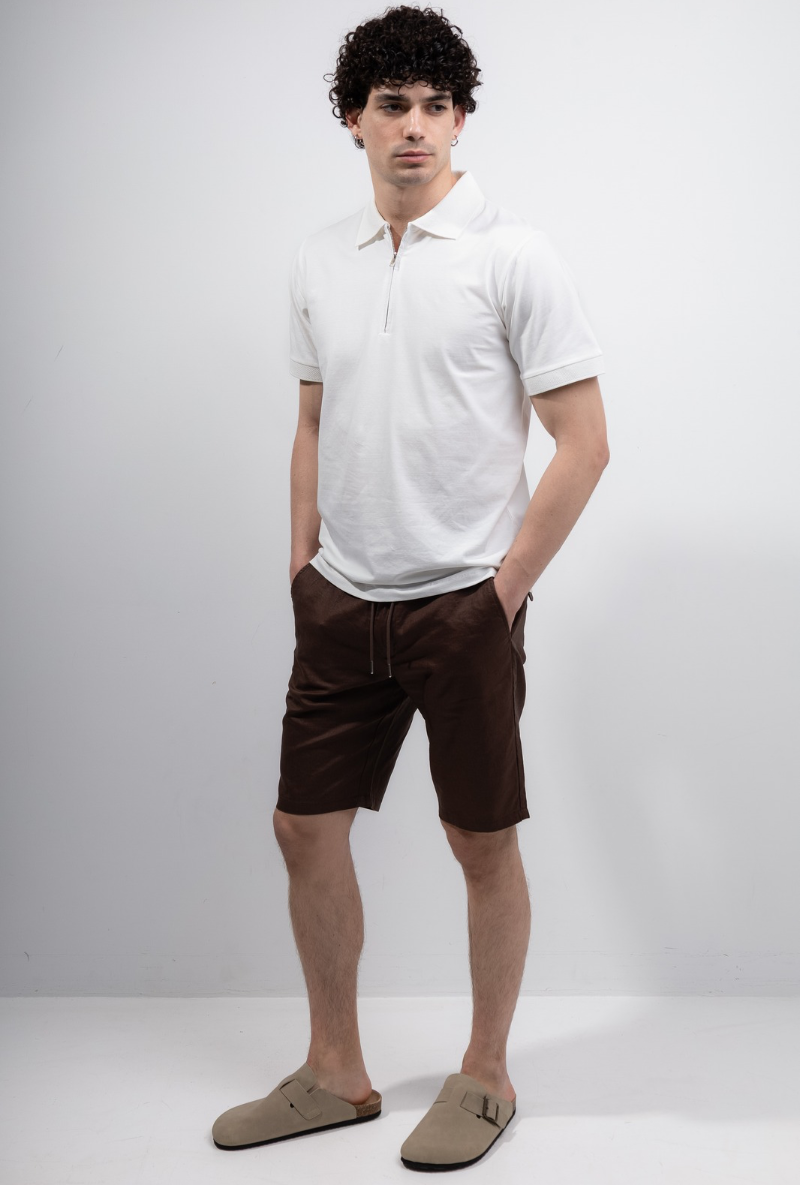 Front image of a model wearing Deep premium polo in white, by brand Deep