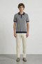 Front image of a model wearing Deep riley stripe polo in navy, by brand Deep