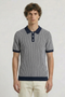 Front image of a model wearing the Deep riley stripe polo in navy, by brand Deep