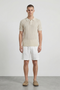 Front image of a model wearing Deep river button knit polo in beige, by brand Deep