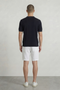 Back image of a model wearing the Deep river button knit polo in black, by brand Deep