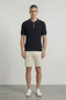 Front image of a model wearing Deep river button knit polo in black, by brand Deep