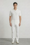 Front image of a model wearing Deep river button knit polo in white, by brand Deep