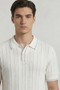 Front image of a model wearing the Deep river button knit polo in white, by brand Deep