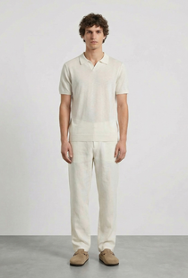 Front image of a model wearing the Deep rocco open neck polo in off white, by brand Deep