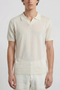 Front image of a model wearing the Deep rocco open neck polo in off white, by brand Deep