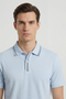 Front image of a model wearing the Deep roman button polo in light blue, by brand Deep