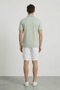 Back image of a model wearing the Deep roman button polo in light green, by brand Deep