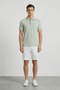 Front image of a model wearing Deep roman button polo in light green, by brand Deep