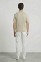 Back image of a model wearing the Deep rory open neck polo in beige, by brand Deep