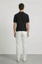 Back image of a model wearing the Deep rory open neck polo in black, by brand Deep