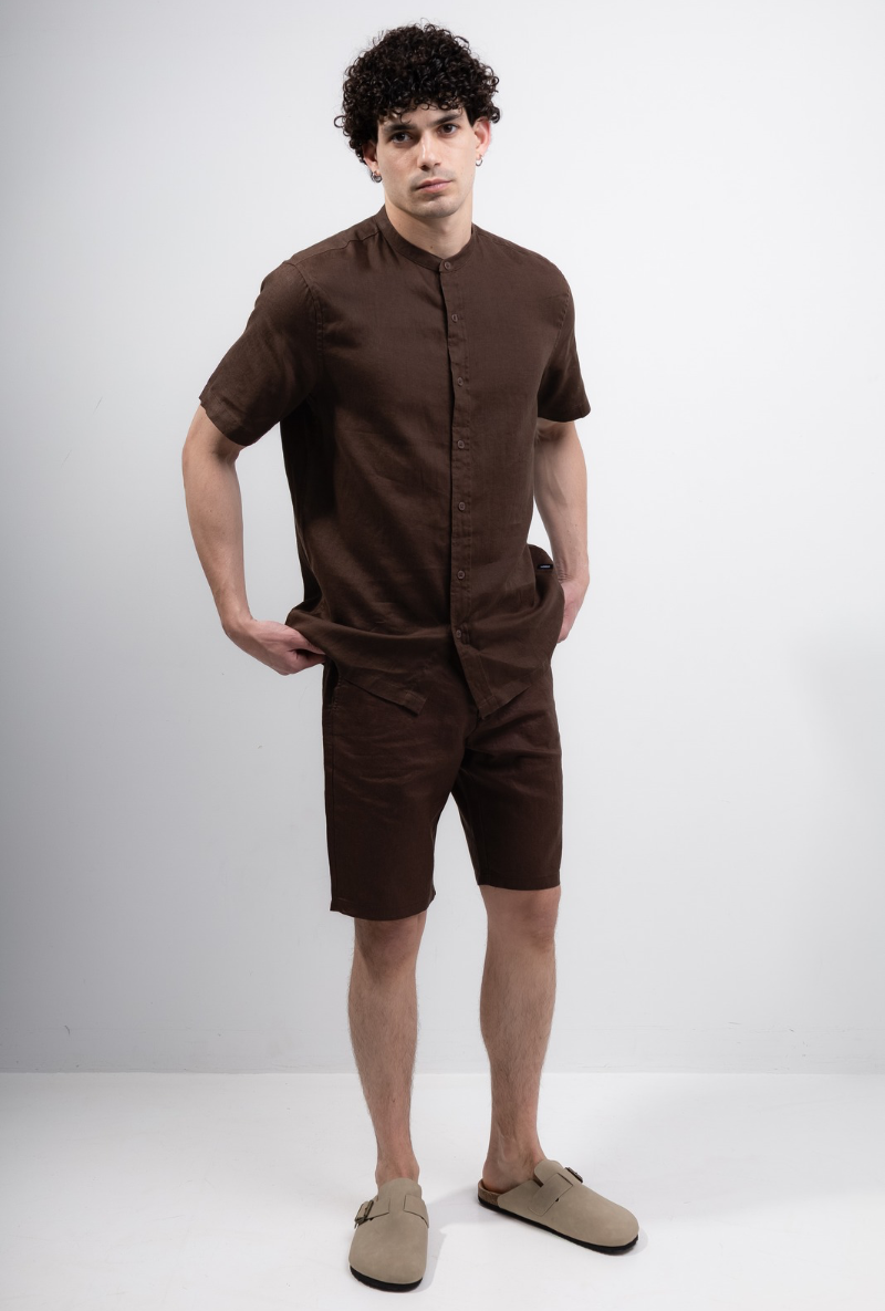 Front image of a model wearing Deep strike linen shirt in brown, by brand Deep