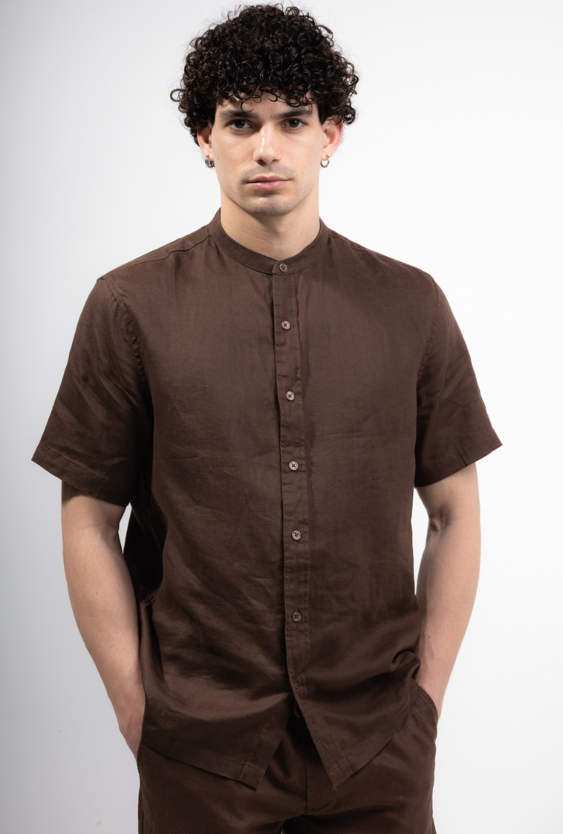 Front image of a model wearing Deep strike linen shirt in brown, by brand Deep