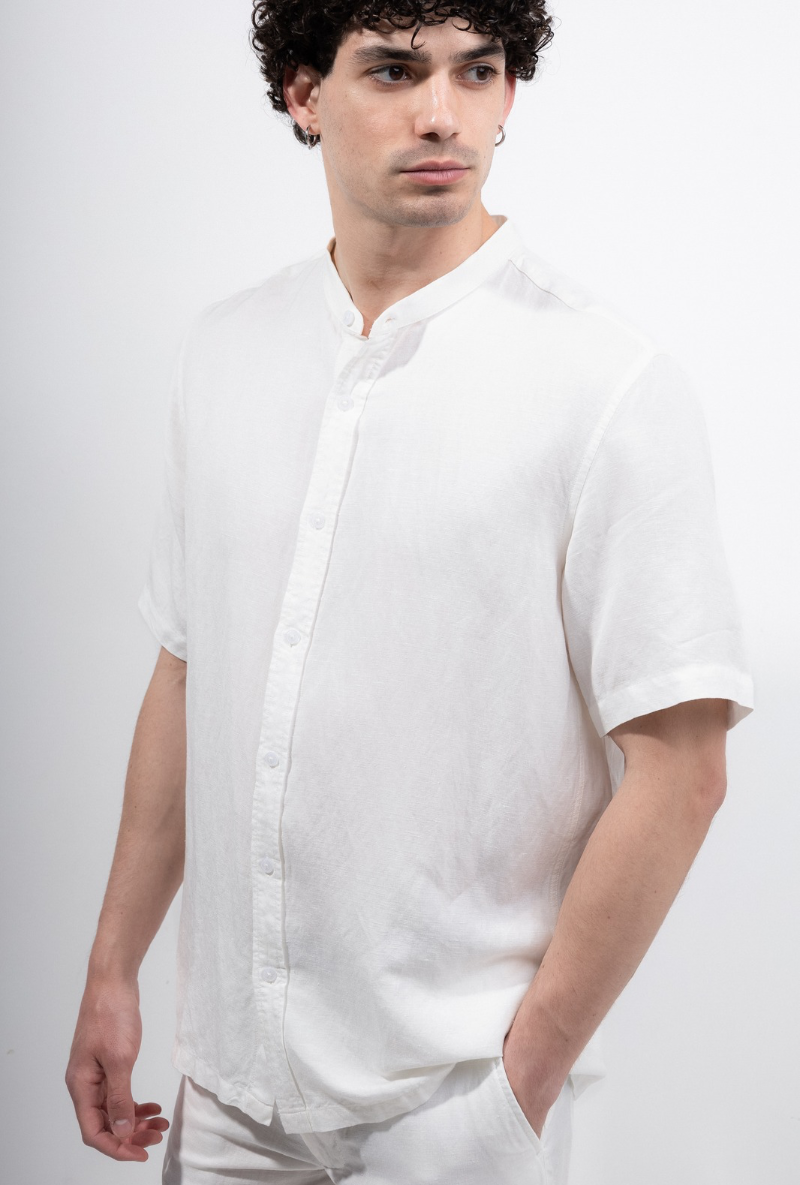 Front image of a model wearing Deep strike linen shirt in off white, by brand Deep