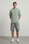 Front image of a model wearing the Deep troy s/s tshirt in khaki, by brand Deep