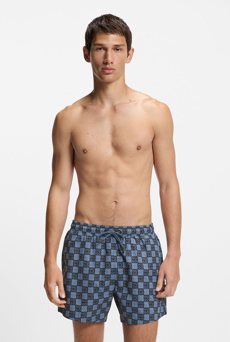 Front image of a model wearing Hugo aaron swimshorts in navy, by brand Hugo