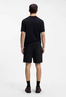 Back image of a model wearing the Dagety sweat shorts in black, by brand Hugo