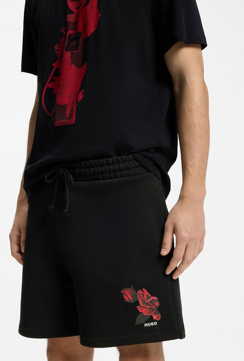 Front image of a model wearing Dagety sweat shorts in black, by brand Hugo
