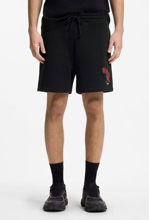 Front image of a model wearing Dagety sweat shorts in black, by brand Hugo