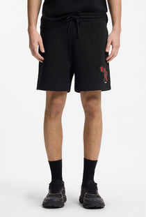 Front image of a model wearing the Dagety sweat shorts in black, by brand Hugo