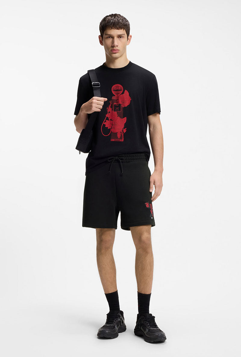 Front image of a model wearing Dagety sweat shorts in black, by brand Hugo