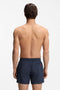 Back image of a model wearing the Dominica swimshorts in navy, by brand Hugo