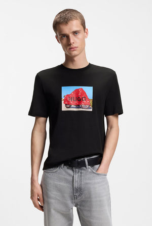 Front image of a model wearing the Dostino t in black, by brand Hugo
