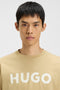 Front image of a model wearing the Dulivio t in beige, by brand Hugo