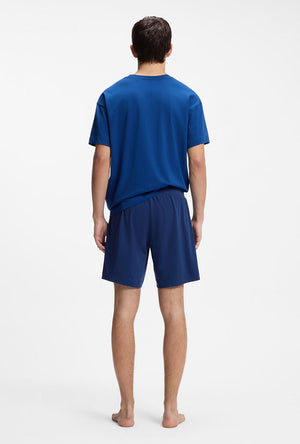 Back image of a model wearing the Laze shorts in blue, by brand Hugo