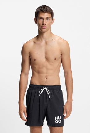 Front image of a model wearing Paolo swimshorts in black, by brand Hugo