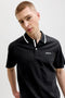 Front image of a model wearing the Blaze s/s polo in black, by brand Jack&jones