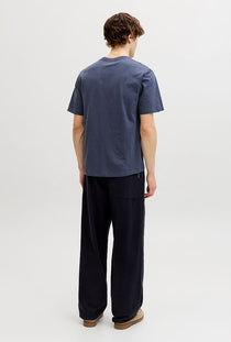 Back image of a model wearing the Montauk aop pocket tee in navy, by brand Jack&jones