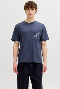 Front image of a model wearing the Montauk aop pocket tee in navy, by brand Jack&jones
