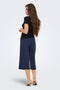 Back image of a model wearing the Catie s/s assymetric top in black, by brand Jacqueline de yong