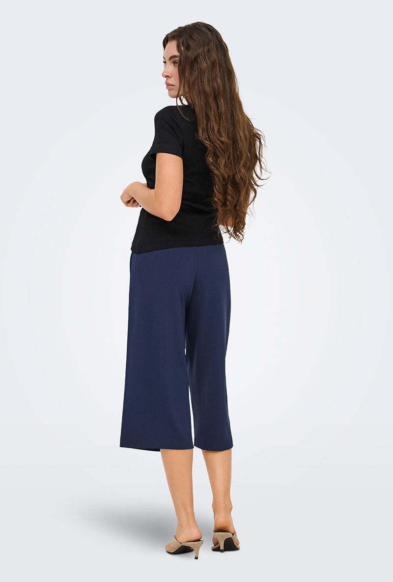 Back image of a model wearing Catie s/s assymetric top in black, by brand Jacqueline de yong
