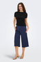 Front image of a model wearing the Catie s/s assymetric top in black, by brand Jacqueline de yong