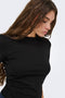 Front image of a model wearing the Catie s/s assymetric top in black, by brand Jacqueline de yong