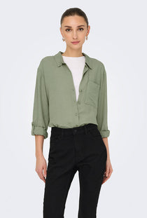Front image of a model wearing the Caya linen loose l/s shirt in sage, by brand Jacqueline de yong