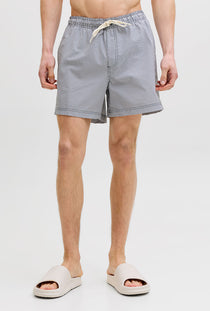 Front image of a model wearing the Maui ocean seersucker swimshorts in navy, by brand Jack&jones
