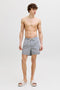 Front image of a model wearing the Maui ocean seersucker swimshorts in navy, by brand Jack&jones