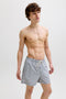 Front image of a model wearing the Maui ocean seersucker swimshorts in navy, by brand Jack&jones